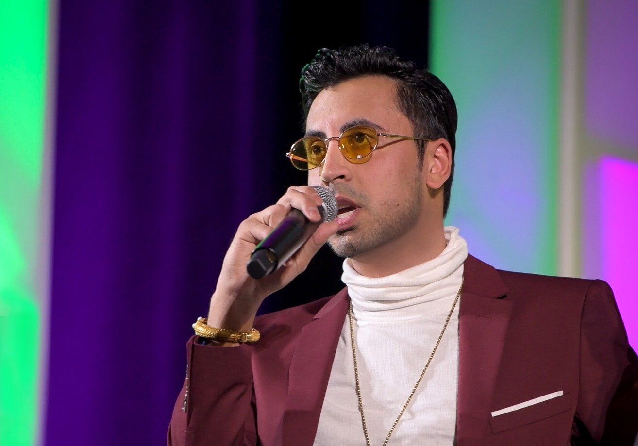 Fam Mirza speaking onstage