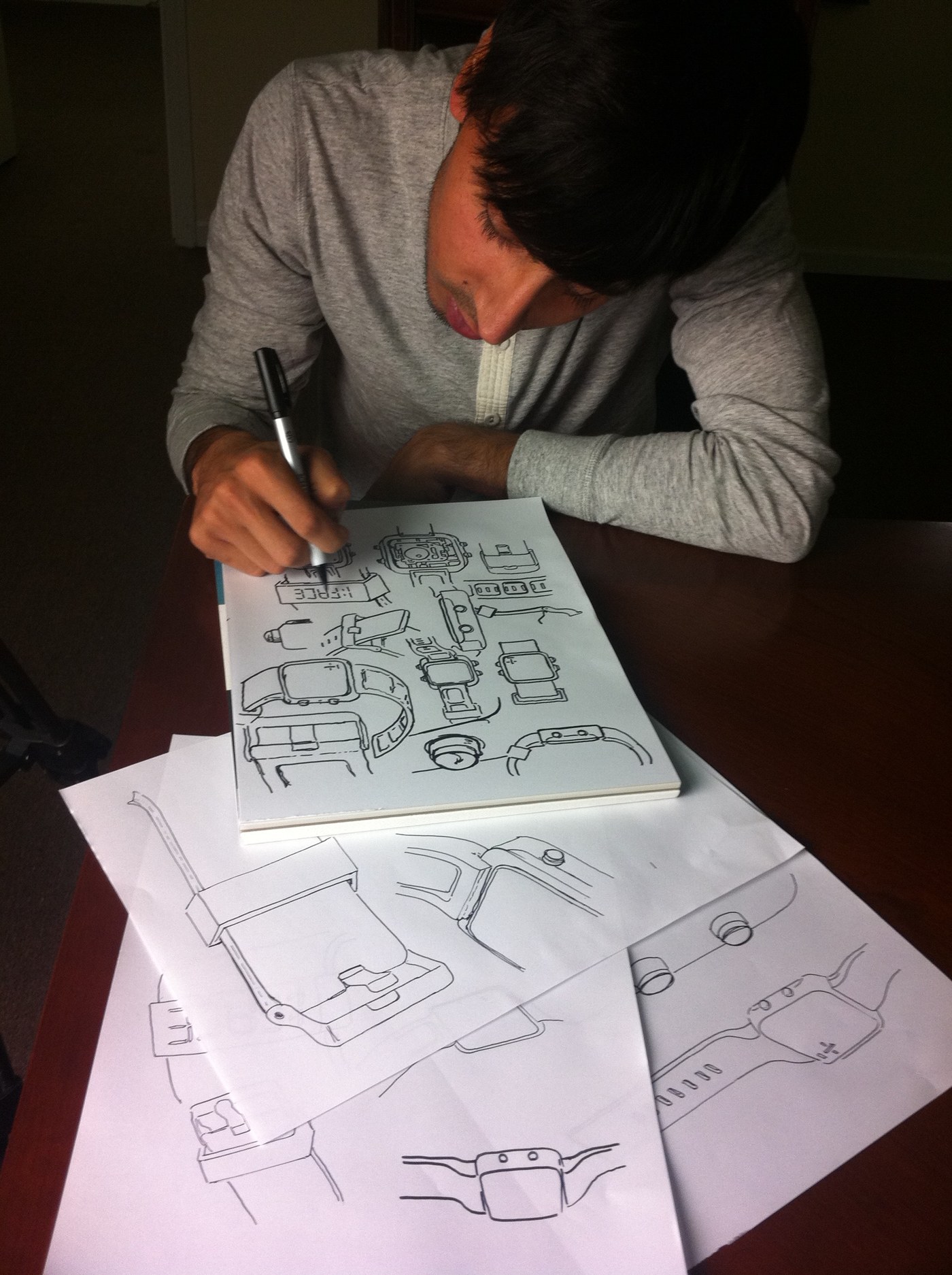 Fam Mirza sketching watch designs at a table